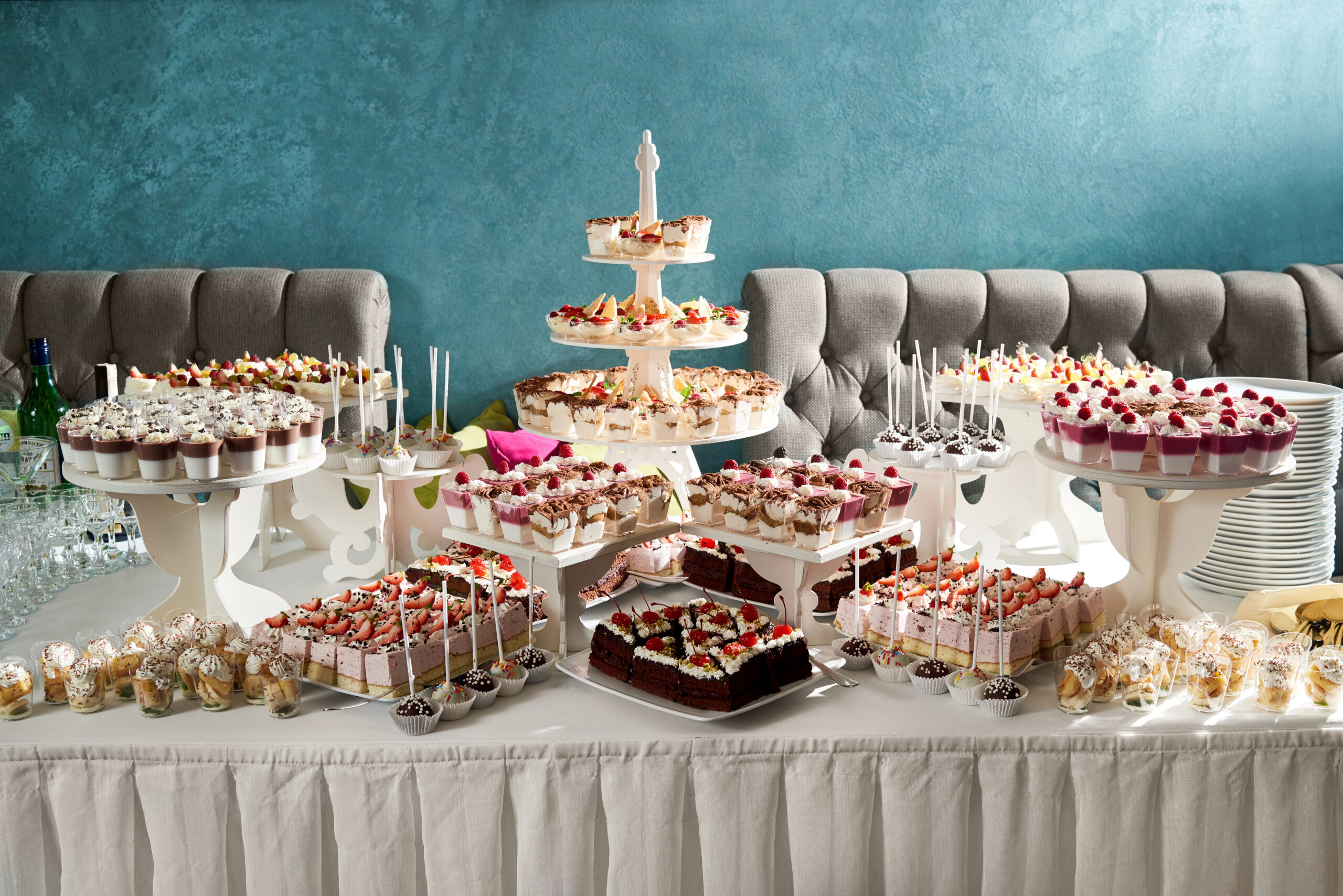 Horizontal shot of a candy buffet at the restaurant table full of delicious desserts cakes cheesecakes creamy sweets party festive gathering cafe confectionery celebration.
